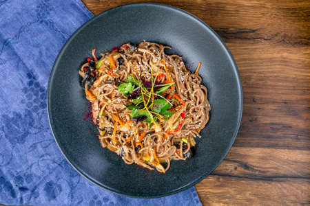 Buckwheat noodles with duck and mushrooms. Asian cuisine. The work of a professional chef. Dish from a restaurant or cafe menu. Close-up.の写真素材