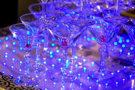 A pyramid of empty martinas in the restaurant. Table setting for celebration. Banquet service,...