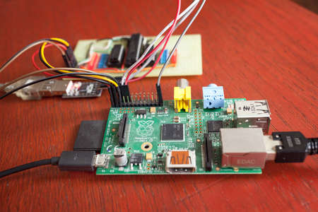 LJUBLJANA, SLOVENIA - SEPTEMBER 18, 2015: Photo showing a Raspberry Pi single board computer used in a tabletop experiment, connected with home-brewed circuit with some of the LEDs on. LJUBLJANA, SLOVENIA - SEPTEMBER 18, 2015: Photo showing a Raspberry Pi single board computer used in a tabletop experiment, connected with home-brewed circuit with some of the LEDs on.
