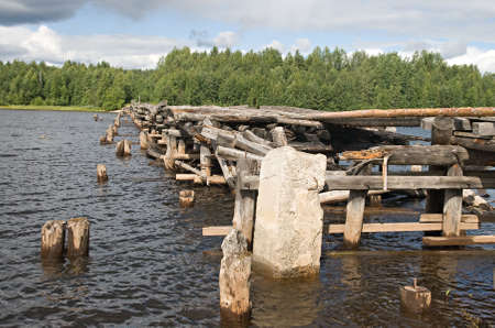 An old broken bridge on a river in Karelia, Russia の写真素材
