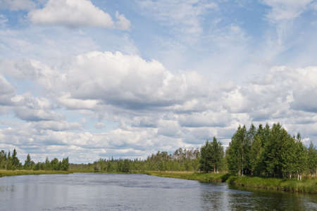 Landscape of Karelian lake and sky with cloudsの写真素材