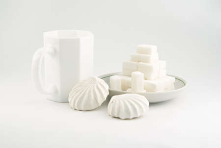 Still life with white sweets over white backgroundの写真素材