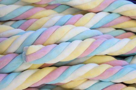 Four-colored blue, pink, yellow, white marshmallow, close upの写真素材