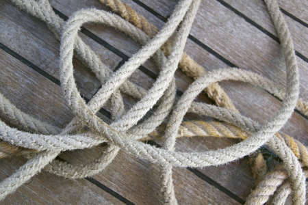 Close-up of thick textile ropes laying on a ship's deck