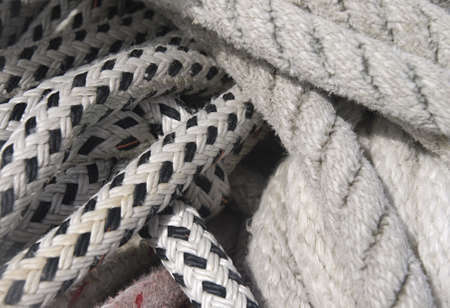 Close-up of thick textile ropes laying on a ship's deck