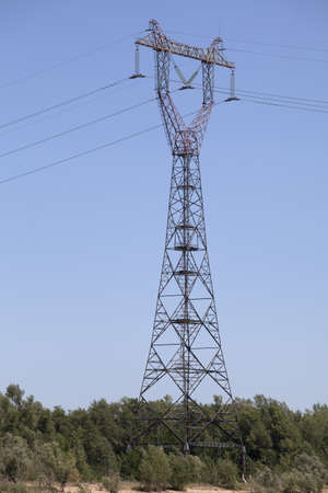 Power transmission tower against blue skyの写真素材