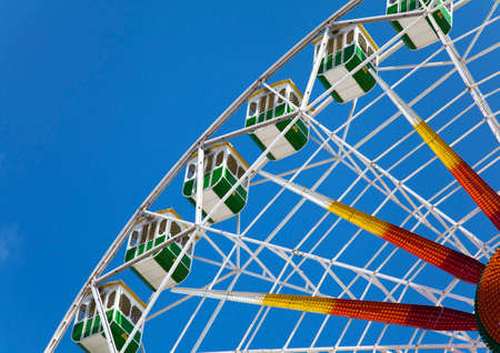 Fragment of a ferris wheel against clear blue skyの写真素材