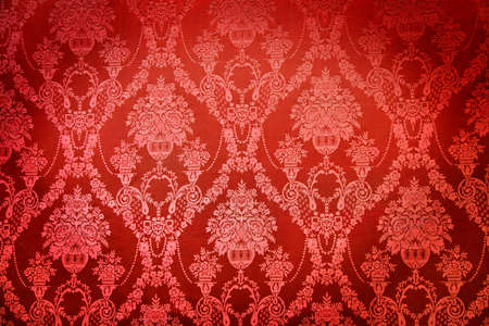Old red textile wall covering in a palace