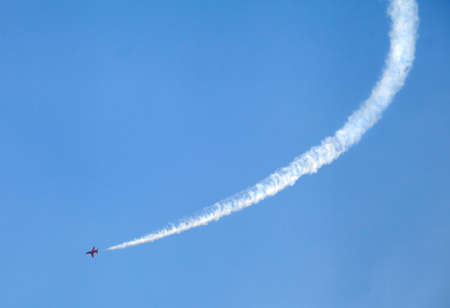 Plane on an air show against blue sky