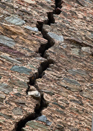 Cracked red brick wall of a medieval fortressの写真素材