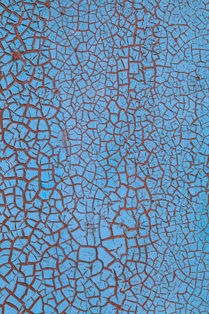 Close-up of peeling paint and rust on a wall