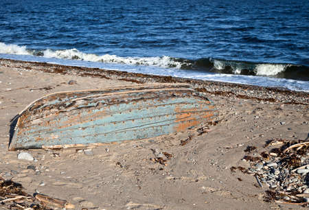 Old abandoned boat on a shore of White seaの写真素材