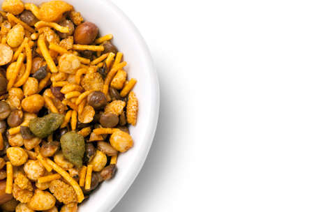 Dry roasted Indian snack mix in a big spoon, isolatedの写真素材