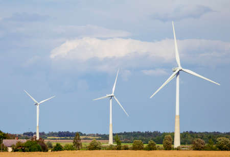 Wind generators in a fieldの写真素材