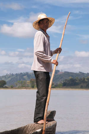 Dak Lak, VIETNAM - JANUARY 6, 2015 - Man pushing a boat with a poleのeditorial素材