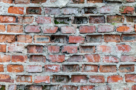 Close-up of old wall with brickwork under plaster