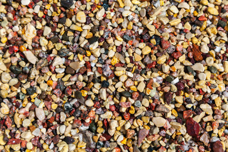 Wet colorful pebbles on a sea shore, natural background