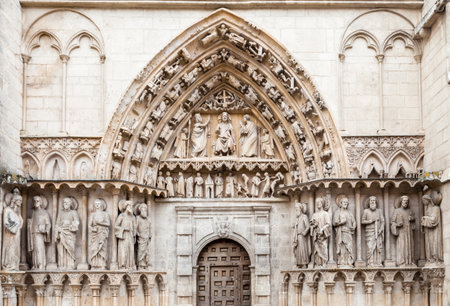 Detailed stone facade of the Cathedral in Burgos, Spain, with its gothic artwork.の写真素材