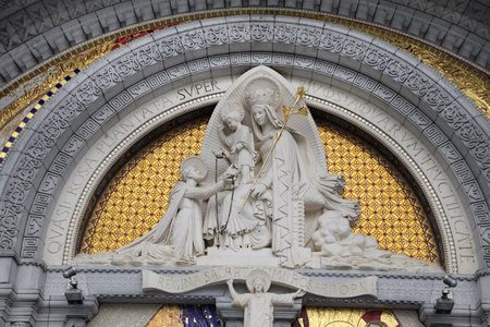 A beautiful Virgin Mary statue in Lourdes, encircled by stunning architecture and deep spiritual meaning.の写真素材