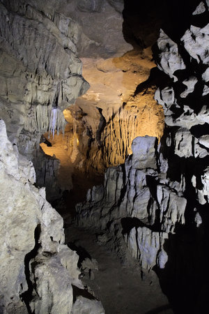 Impressive stalactites and stalagmites within the Betharram caves, illuminated by soft lighting.の写真素材