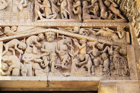 Stone reliefs showcase detailed figures and events from history, offering insight into the art of Conques, France.の写真素材