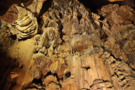 Visitors admire the intricate rock formations in Padirac Cave while exploring its stunning subterranean wonders.の写真素材