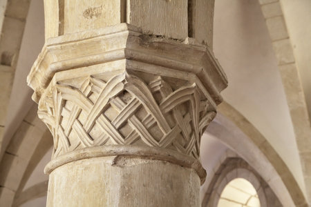 Intricate stonework adorns a column at Monastery Santa Maria