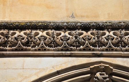 Detailed stonework showcases the remarkable craftsmanship of the Batalha Monastery. This historical site in Portugal reflects Gothic style and rich artistic heritage, attracting visitors worldwide.の写真素材