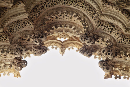 Intricate stone carvings adorn the entrance of Unfinished Chapels in Batalha monastery in Portugal showcasing medieval craftsmanshipの写真素材