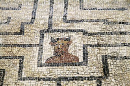 A detailed mosaic depicting the Minotaur can be seen among ancient Roman ruins in Conimbriga, Portugal, showcasing historical artistryの写真素材