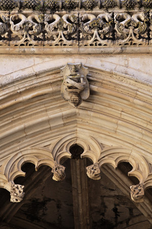 Detailed stone archway displays intricate patterns at Batalha monastery in Portugal showcasing medieval craftsmanshipの写真素材