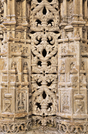 Detailed Gothic architecture of Batalha Monastery's Unfinished Chapels under a clear blue sky