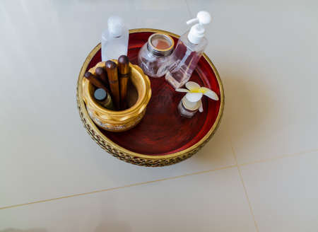 Essential oil bottles, towels, candle and flower in health spa for spa treatment.の写真素材
