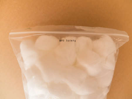 Cotton bales and plastic packing on brown paper backgroundの写真素材