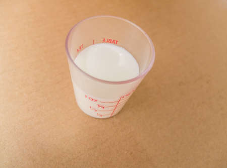 cup of milk on brown paper backgroundの写真素材