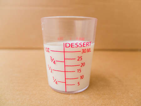 cup of milk on brown paper backgroundの写真素材