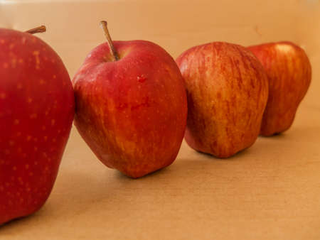 Fresh red apple isolated on brown paper background.の写真素材