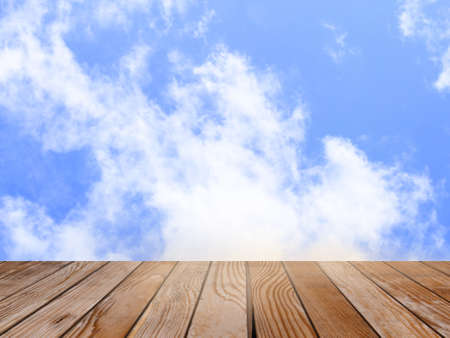 Empty wood table over blurred blue sky with bokeh background, product display template,deck,の写真素材