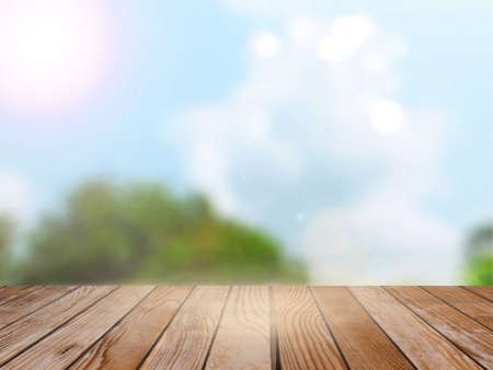 Empty wood table over blurred trees and blue sky with bokeh background, product display template,deck,の写真素材