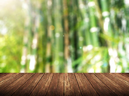 Empty wood table over blurred bamboo forest with bokeh background, product display template,deck,の写真素材