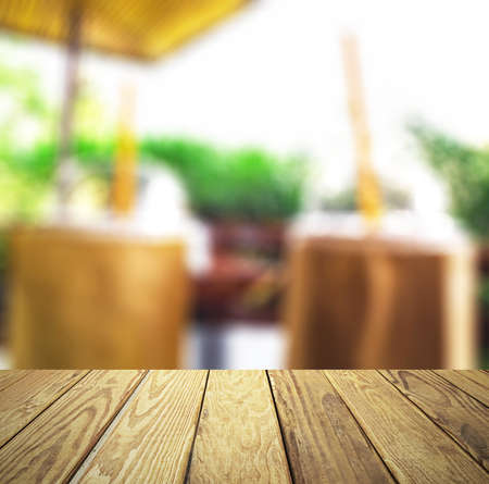 Empty wood table over blurred coffee shop with bokeh background, product display template,deck,