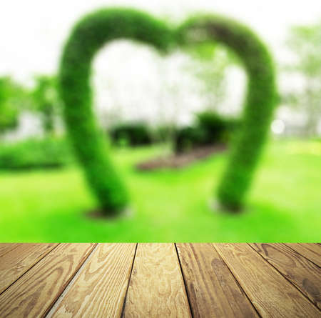 Empty wood table over blurred green garden with bokeh background, product display template,deck,の写真素材