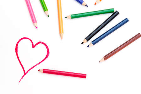 Heart Shape Drawing on White Paper and Crayonsの写真素材