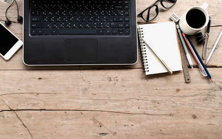 Laptop, Notebook, Smart Phone and Glasses on Wooden Deskの写真素材