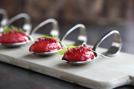 A spoon of strawberry soup with berries の写真素材