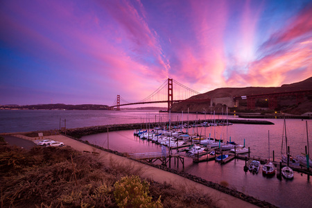 SAUSALITO, CA - SEPTEMBER 30, 2015: Boats moored at Horseshoe Bay, near Fort Baker, Sausalito in California at sunset. The Golden Gate Bridge is in the background.のeditorial素材