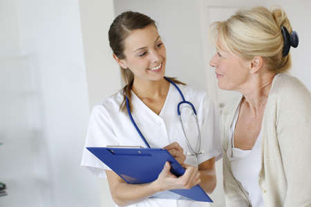 Nurse giving presciption to elderly woman Nurse giving presciption to elderly woman