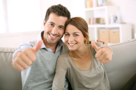 Young couple showing thumbs up Young couple showing thumbs up