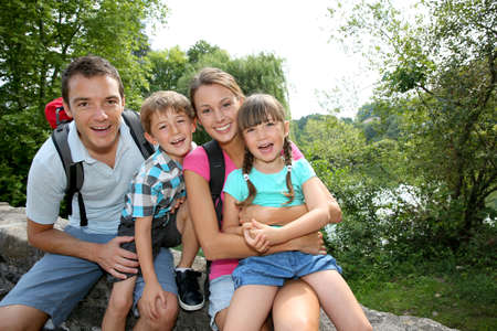 Happy family relaxing on a bridge Happy family relaxing on a bridge