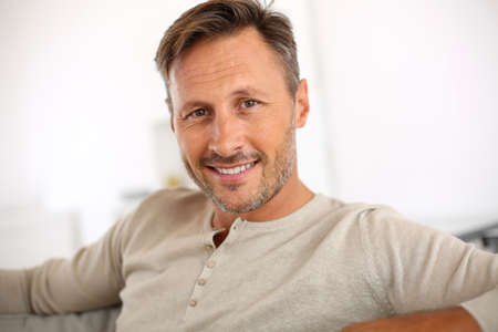 Handsome 40-year-old man relaxing in sofa Handsome 40-year-old man relaxing in sofa